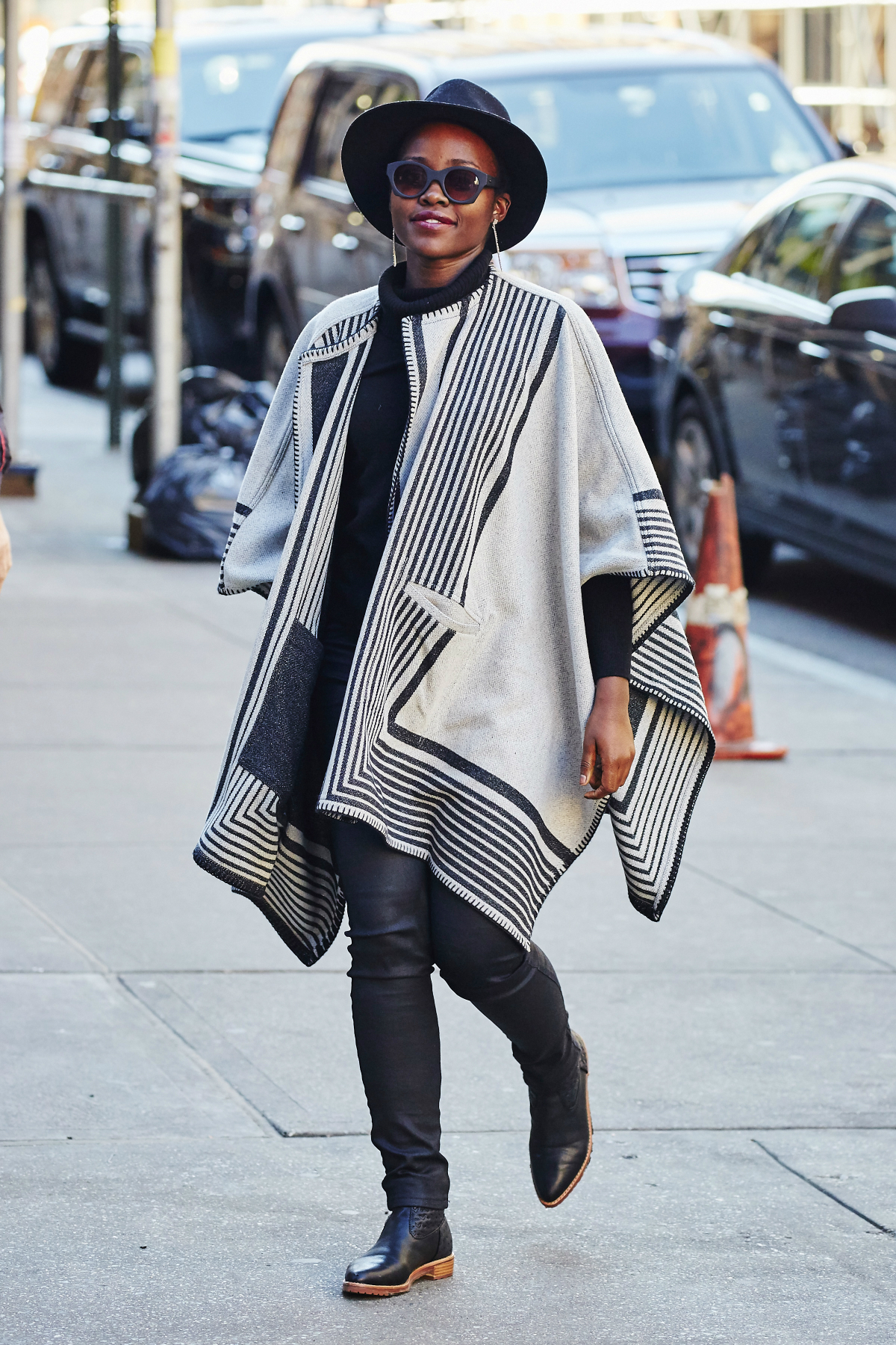 Lupita Nyong'o Stuns In Patterned Robe Coat And Fedora Hat